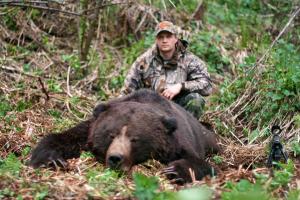 Hunter with grizzly bear